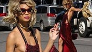 'Chanel Iman narrowly avoiding wardrobe malfunction in cutaway red dress on photoshoot'